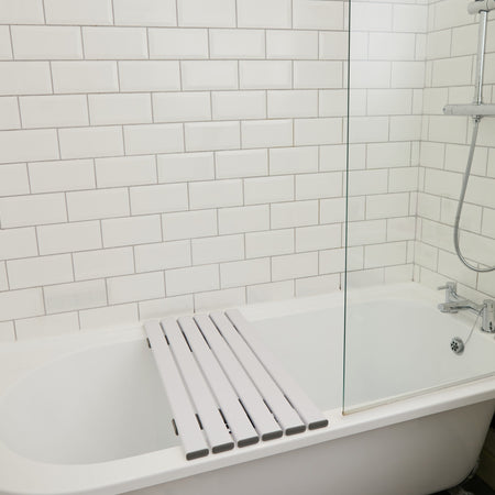 NRS Slatted Shower Board positioned across a bath to demonstrate how it fits and provides a stable seat.