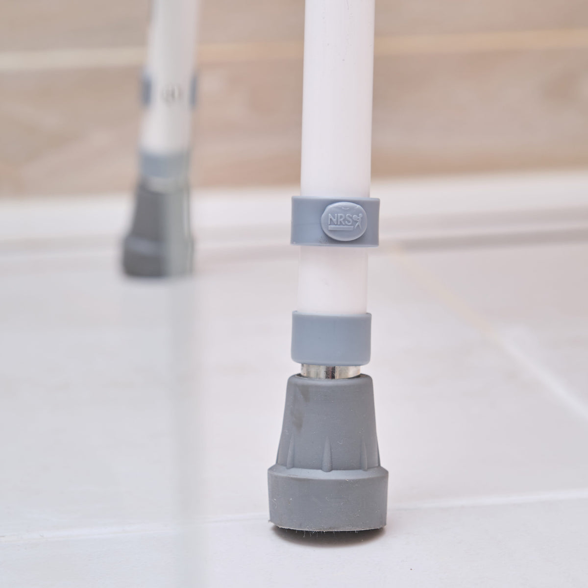 Front view of NRS Stackable Adjustable Shower Chair showing drainage holes in the seat and the supportive backrest design.