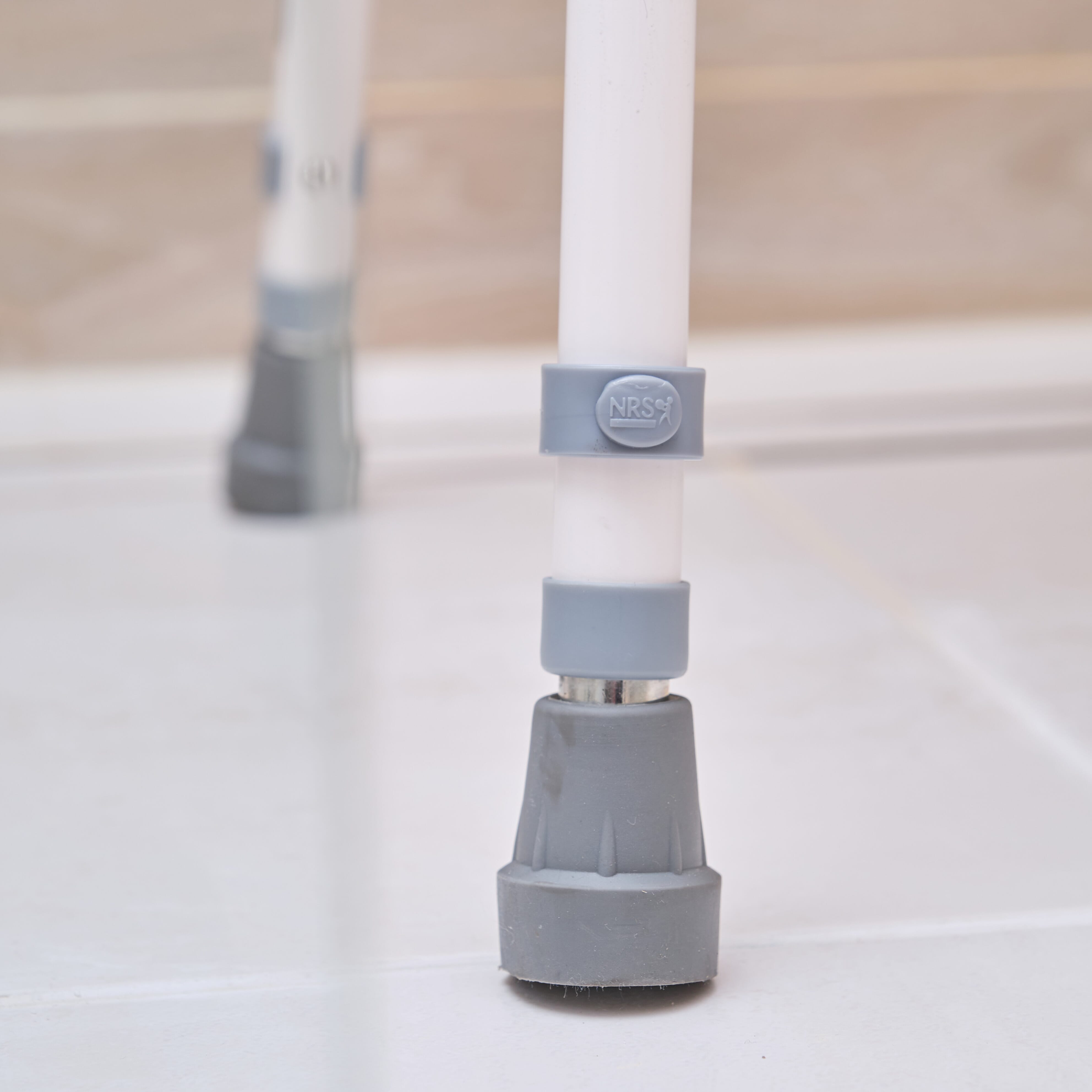 Front view of NRS Stackable Adjustable Shower Chair showing drainage holes in the seat and the supportive backrest design.