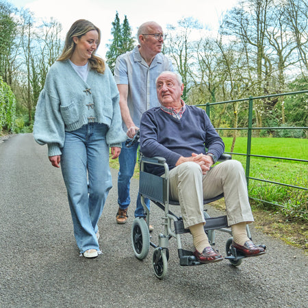 Alternative view of NRS Transit-Lite Attendant Controlled Wheelchair, showing different angle or usage.