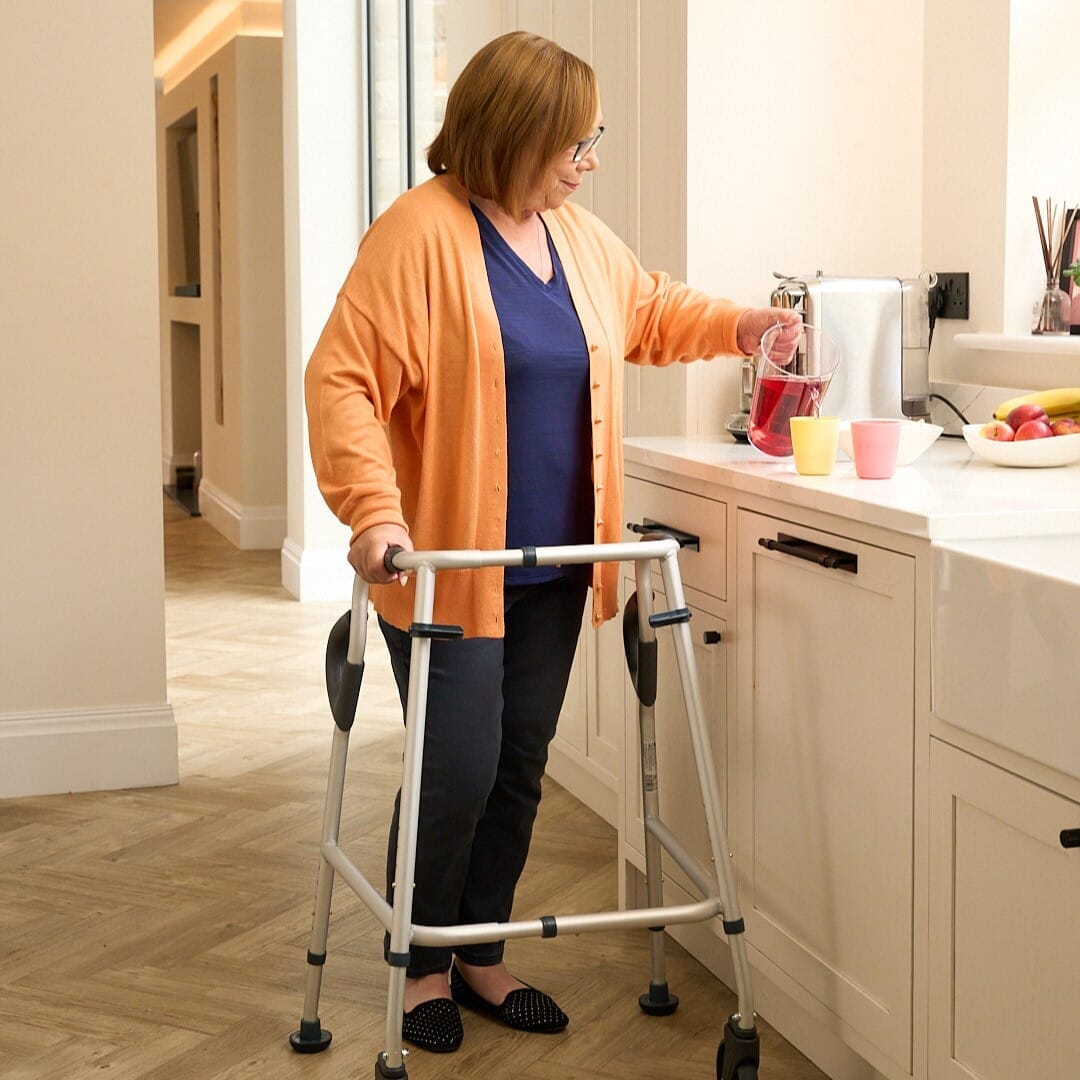 NRS Walk Safe Walking Frame being used in a home environment, demonstrating practical support for daily tasks.