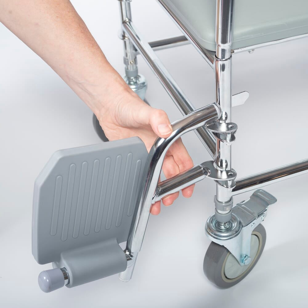 NRS Wheeled Commode Footrests with lid closed, highlighting the padded seat and discreet design.