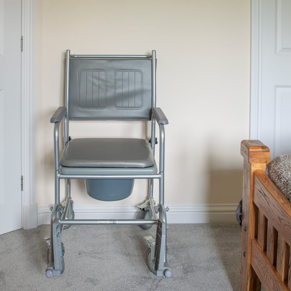 Another close-up of a component of NRS Wheeled Commode such as the lid hinge or flush mechanism.