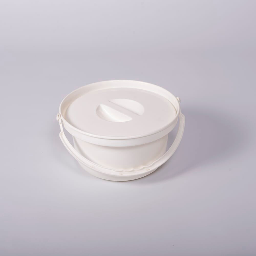 Nuvo Petite Commode Spare Potty with lid closed, highlighting the padded seat and discreet design.