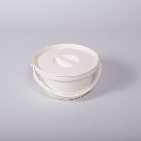 Nuvo Petite Commode Spare Potty with lid closed, highlighting the padded seat and discreet design.