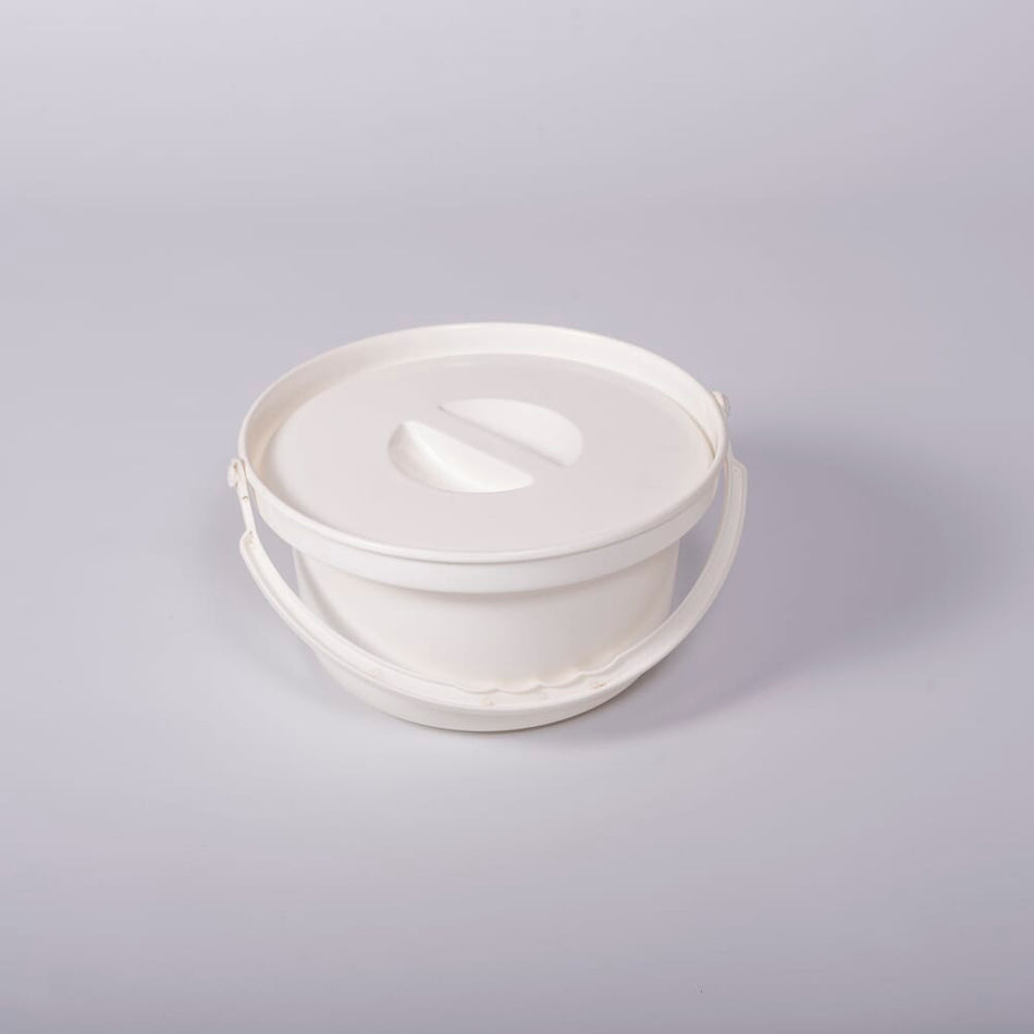 Nuvo Petite Commode Spare Potty with lid closed, highlighting the padded seat and discreet design.