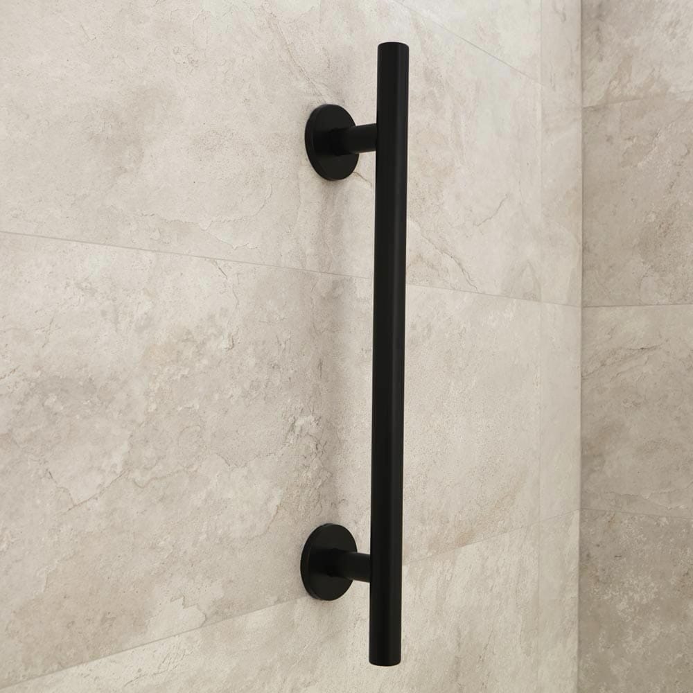 Full view of Nymas Matt Black Straight Grab Rail grab rail with circular wall plates and a textured grip, designed to provide support in bathrooms and other areas.