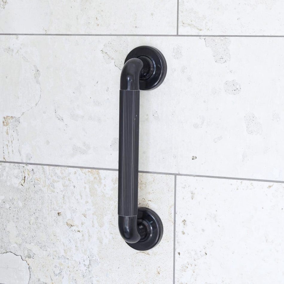 Full view of Plastic Fluted Grab Rail grab rail with circular wall plates and a textured grip, designed to provide support in bathrooms and other areas.