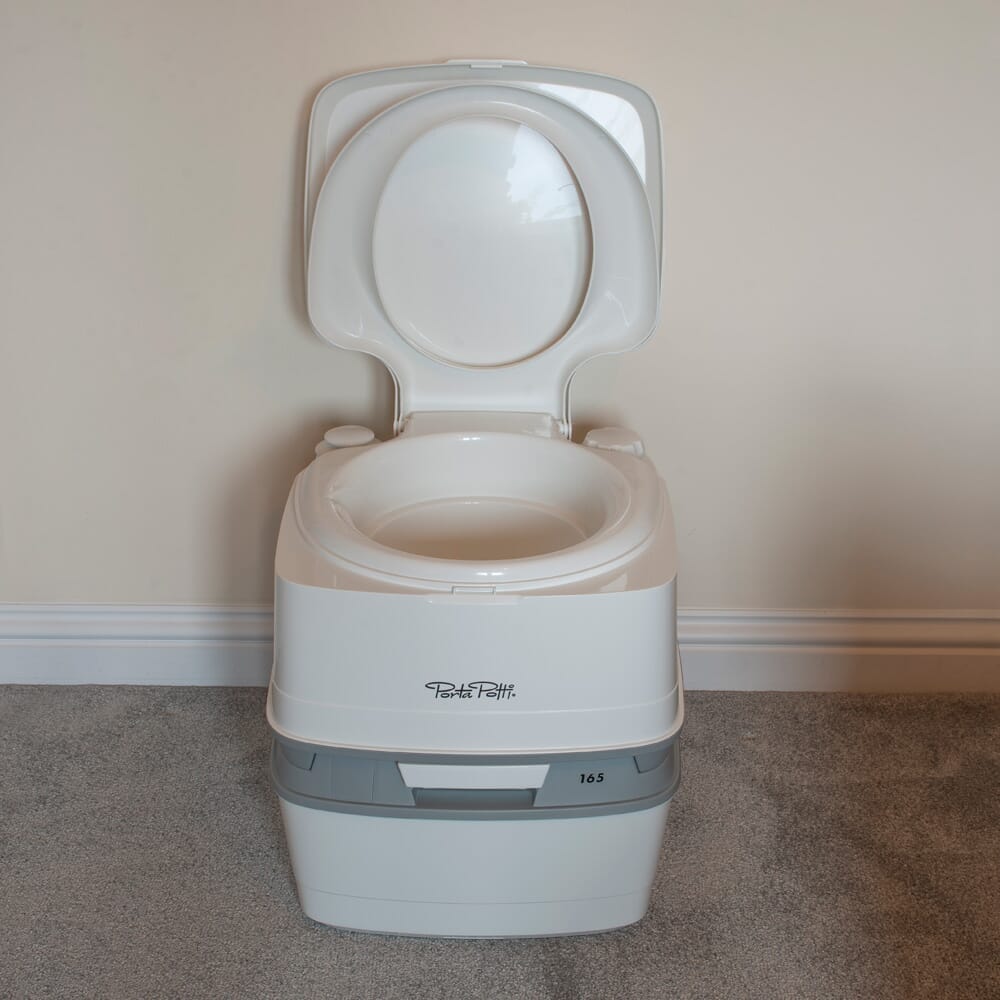 Diagram or packaging of Porta Potti 165 Portable Flushing Toilet highlighting dimensions or features.