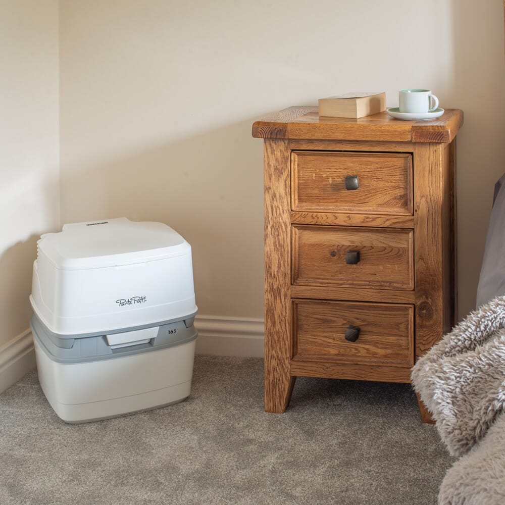 Lifestyle image of Porta Potti 165 Portable Flushing Toilet being used in a real-life setting.