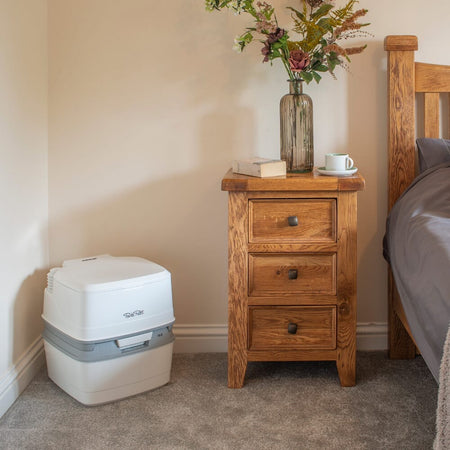 Diagram or packaging of Porta Potti 165 Portable Flushing Toilet highlighting dimensions or features.