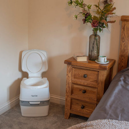 Diagram or packaging of Porta Potti 165 Portable Flushing Toilet highlighting dimensions or features.