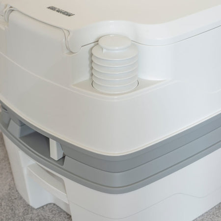 Diagram or packaging of Porta Potti 165 Portable Flushing Toilet highlighting dimensions or features.
