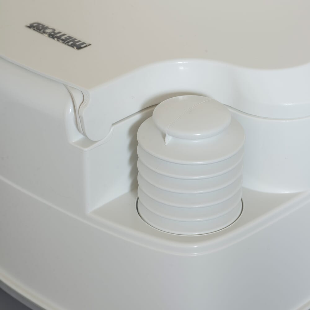 Diagram or packaging of Porta Potti 165 Portable Flushing Toilet highlighting dimensions or features.