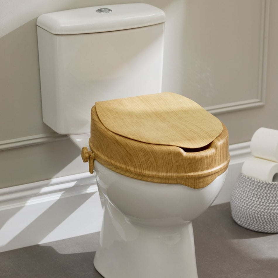 Image of Sanctuary Oak Effect Raised Toilet Seat With Lid on a plain background.