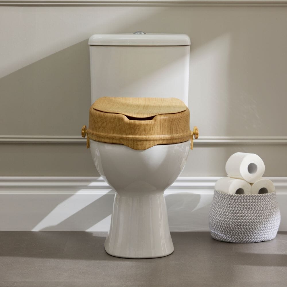 Close-up of a feature of Sanctuary Oak Effect Raised Toilet Seat With Lid.