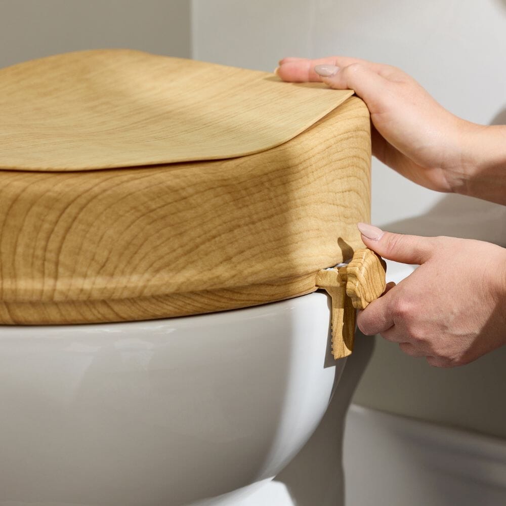 Lifestyle image of Sanctuary Oak Effect Raised Toilet Seat With Lid being used in a real-life setting.