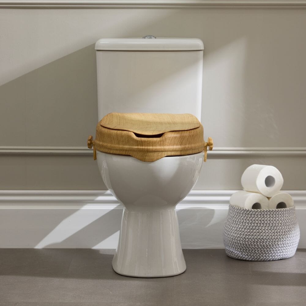 Close-up of a feature of Sanctuary Oak Effect Raised Toilet Seat With Lid.