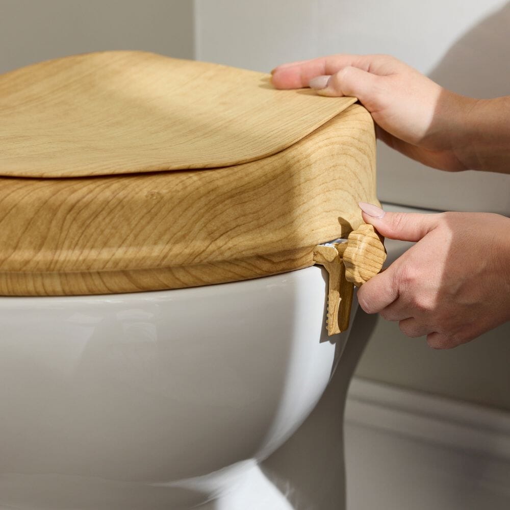 Lifestyle image of Sanctuary Oak Effect Raised Toilet Seat With Lid being used in a real-life setting.