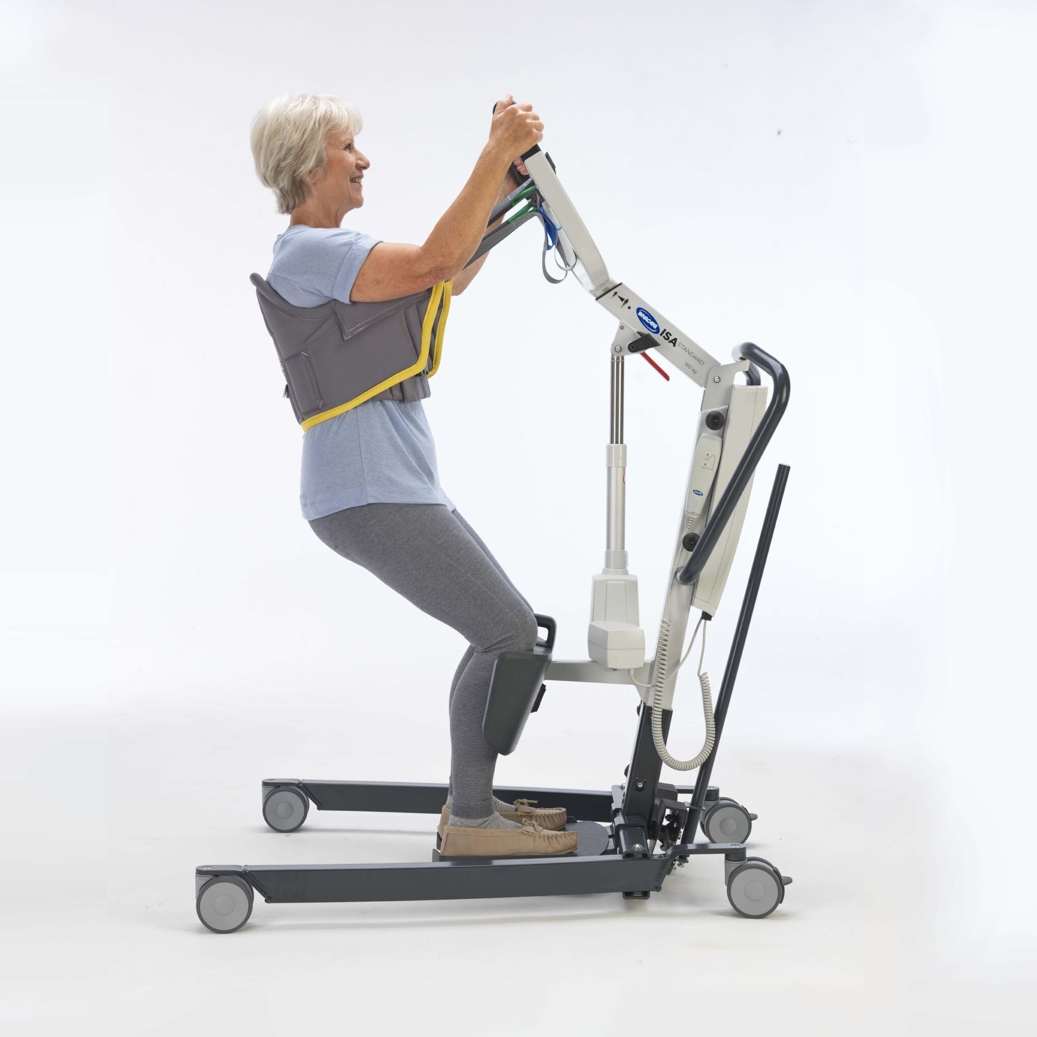 Full view of Stand Aid Sling mobile hoist on a plain background, showing the wheeled base, upright mast and sling attachment.