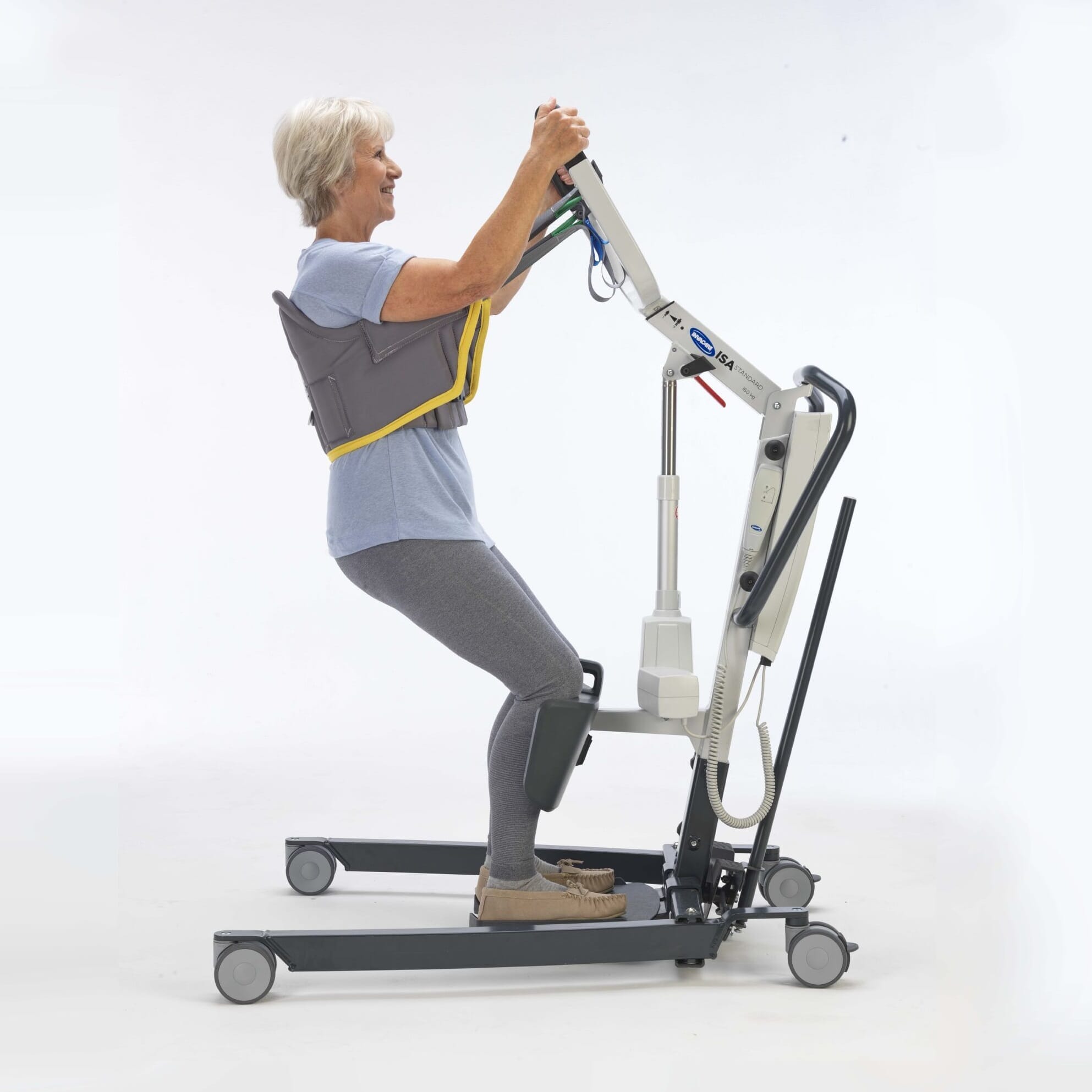 Full view of Stand Aid Sling mobile hoist on a plain background, showing the wheeled base, upright mast and sling attachment.