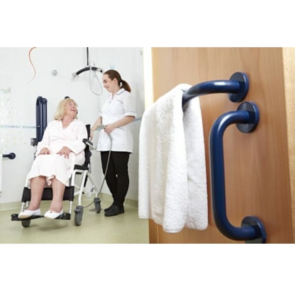 Tilt In Space Shower Commode Chair positioned in a home environment such as a bedroom or bathroom, demonstrating its discreet appearance.