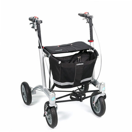 Angled view of Trionic 9er Rollator Walker rollator with seat, padded backrest, storage bag and four wheels on a plain background.